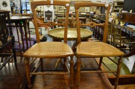 A pair of Victorian cane seated occasional chairs.