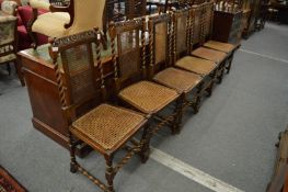 A set of six dining chairs with cane work back panels and seats of barley twist stretchered