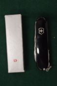A Swiss Army Huntsman knife with black scales and original box.