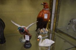 A Beswick cock pheasant with its wings out swept and other birds.