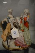 A coloured bisque porcelain conversation group.