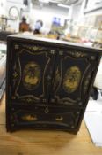 A Japanese chinoiserie decorated lacquer table cabinet.