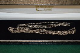 A platinum and diamond long necklace, circa 1920's, of delicate design the chain interspersed with