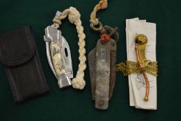 A military knife another knife and a bosuns whistle.