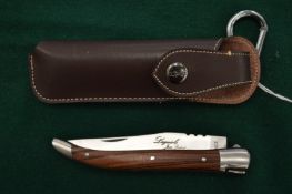 A French Laguiole folding knife with leather scabbard.