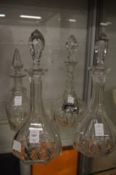 A pair of cut glass decanters and two others.