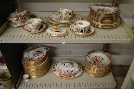 A Spode part dinner service decorated in Imari colours (some faults).