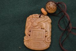 A Chinese jadeite pendant.