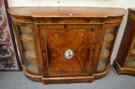 A good Victorian figured walnut credenza, the central panelled door inset with a porcelain
