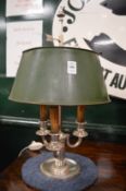 A silver plated three branch table lamp with green toleware shade.