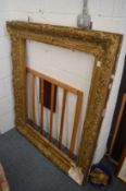 A large gilt picture frame (faults), rebate size 106cm x 86cm.
