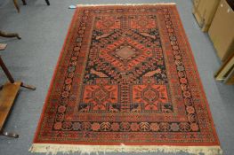 A Persian design carpet, red ground with stylised decoration including birds, 200cm x 140cm.
