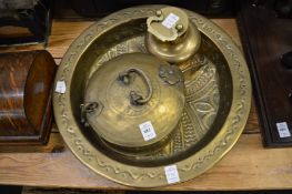An Eastern embossed brass circular bowl, similar box and cover and a storage jar with lid.