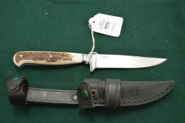 A Puma stag handled knife with leather sheaf.