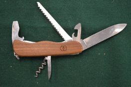 A Swiss Army knife with wooden scales.