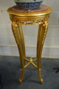 A pair of tall gilt wood and marble inset urn stands.