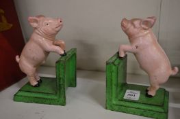 A pair of novelty cast iron bookends modelled as pigs.