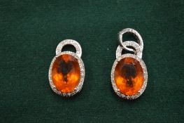 A pair of decorative earrings.