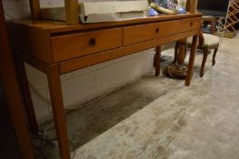 A teak three drawer side table.
