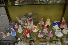 A collection of small Doulton figurines.