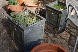 A pair of square shaped faux lead garden planters.