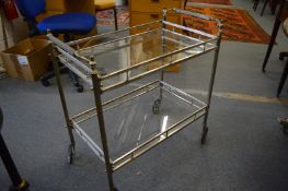 A decorative nickel plated two-tier glazed cocktail trolley.