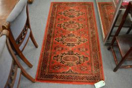 A machine made Persian style rug, 160cm x 83cm.