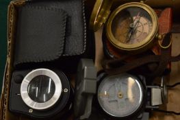 Two compasses and a magnifying device.