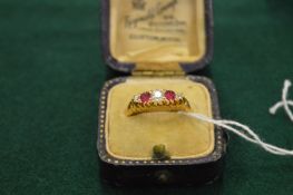 An 18ct gold diamond and ruby five stone ring.