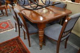 An oak dining table on turned supports.