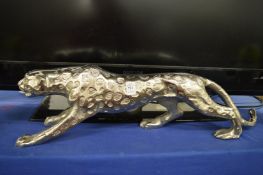 A large polished cast steel model of a cheetah or leopard.