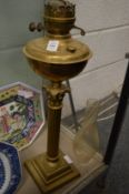 A brass corinthian column oil lamp.