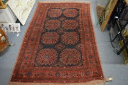 A Persian carpet, the central panel with eight large medallions, 200cm x 130cm.