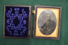 Early photograph of a gentleman in a folding travelling case (case faulty).