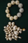 Decorative pearl brooch and bracelet.