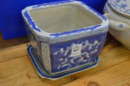 A Chinese blue and white jardiniere and stand.