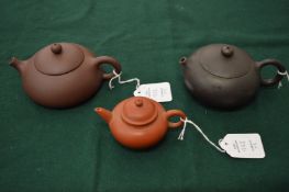Three small Chinese Yixing teapots.