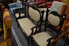 An early 20th century mahogany stained three piece salon suite comprising settee and pair of