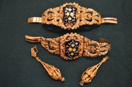 A pair of decorative yellow metal and enamel bracelets and a pair of yellow metal filigree
