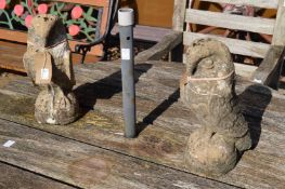 A pair of reconstituted stone gate post finials modelled as eagles.