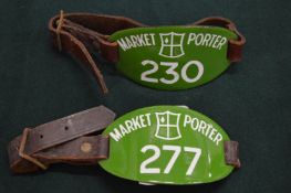 A pair of enamel and leather market porters badges.