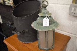 An old lantern, coal bucket, coal and other items.