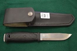 A Morakniv sheaf knife with leather scabbard.