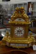 A good French ormolu mantel clock with pink Sevres panels.