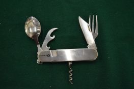 A stainless steel folding camping knife, fork and spoon set.