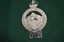 A Royal East African Automobile Association car badge.