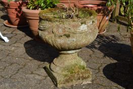 A good weathered pair of reconstituted stone pedestal urns.