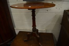 A Victorian mahogany oval tripod table.