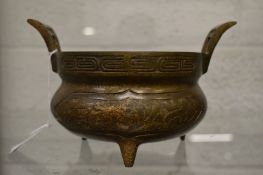 A Chinese bronze twin handled censer.