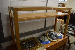 An modern light oak and glass console table.